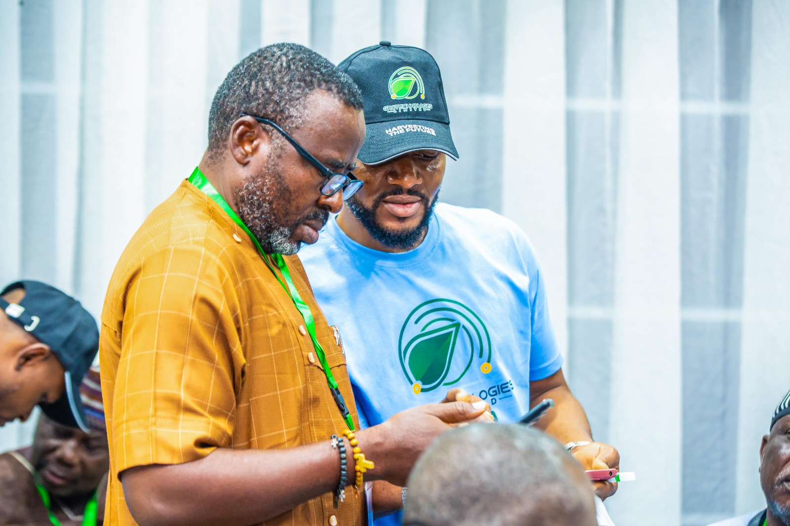 Team member assisting farmer with mobile registration